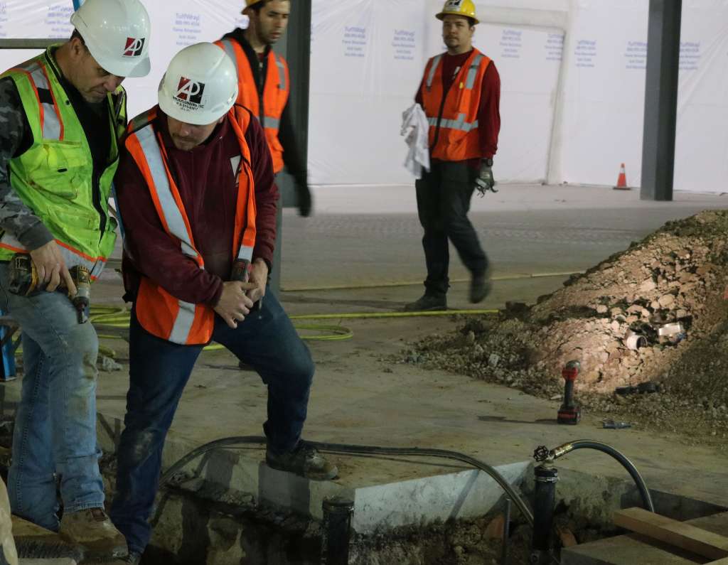 People inspecting their work